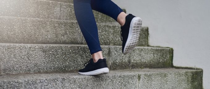 woman's feet running up steps